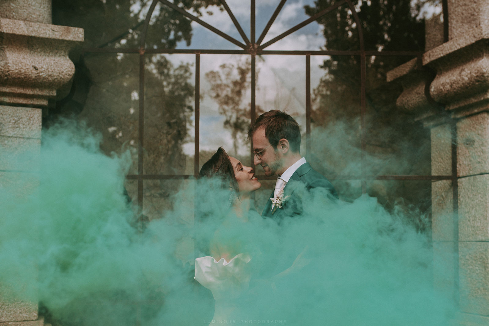 interracial couple kissing romantically with smoke bomb