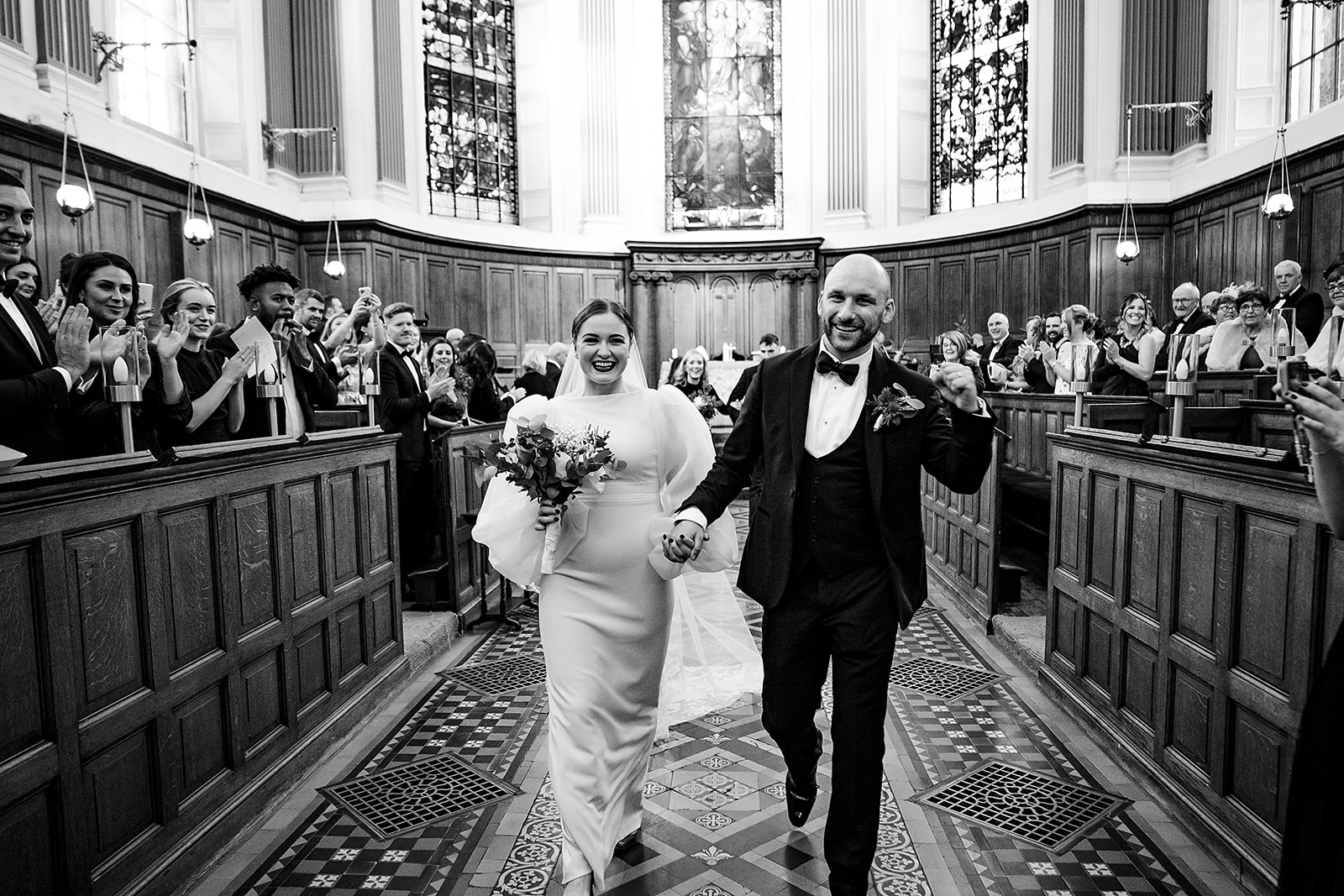 newly married couple exiting trinity college chapel in dublin wedding photograph