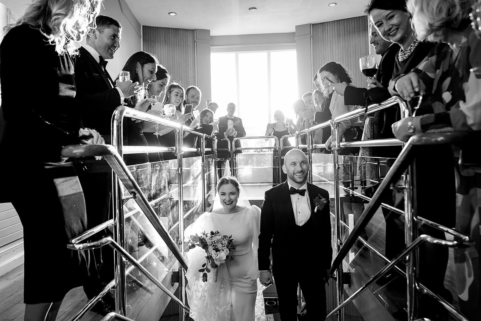 wedding couple walking into Howth Yacht club after their ceremony