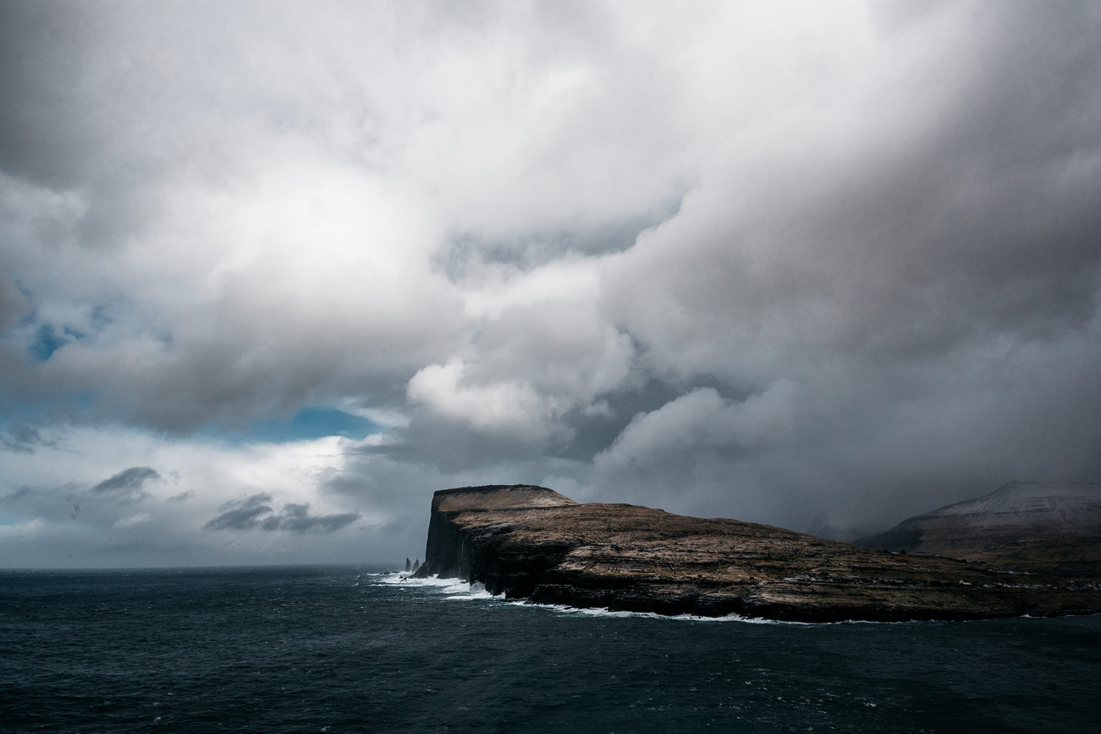 Iconic cliff against rough sea
