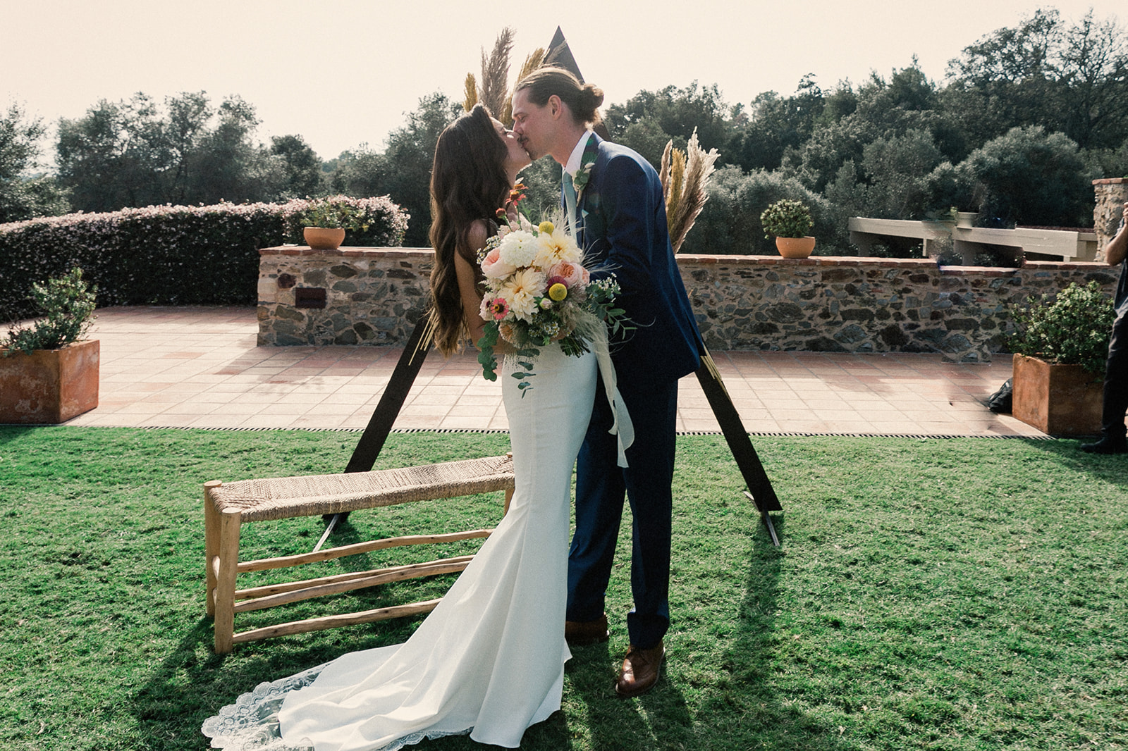a couple kiss right after they get married at a mansion in the costa brava, at the wedding venue called Mas Torroella