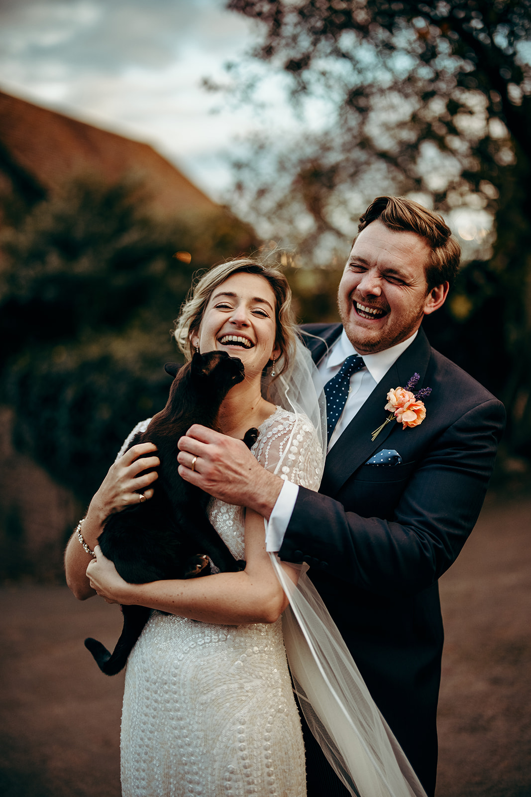 bride and groom  being congratulated by their cat