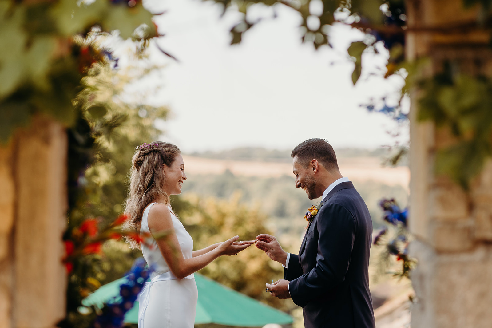 couple exchanging wedding rings at outdoor uk wedding
