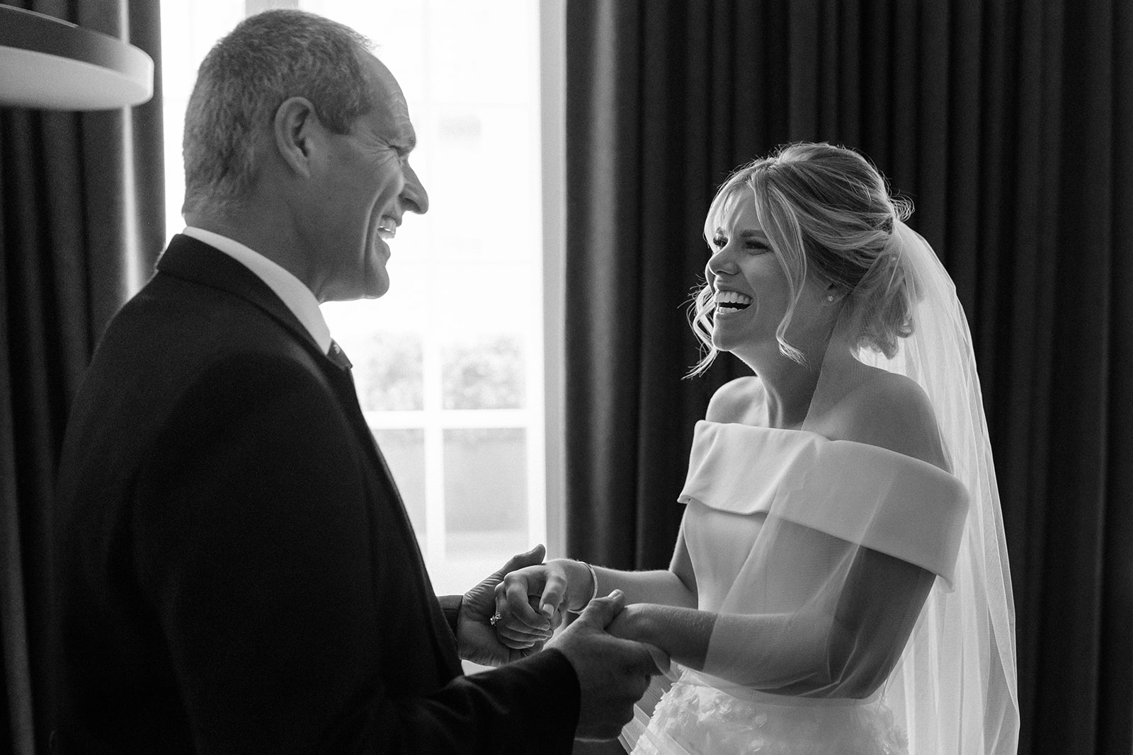 father of bride looking at daughter in wedding dress for first time