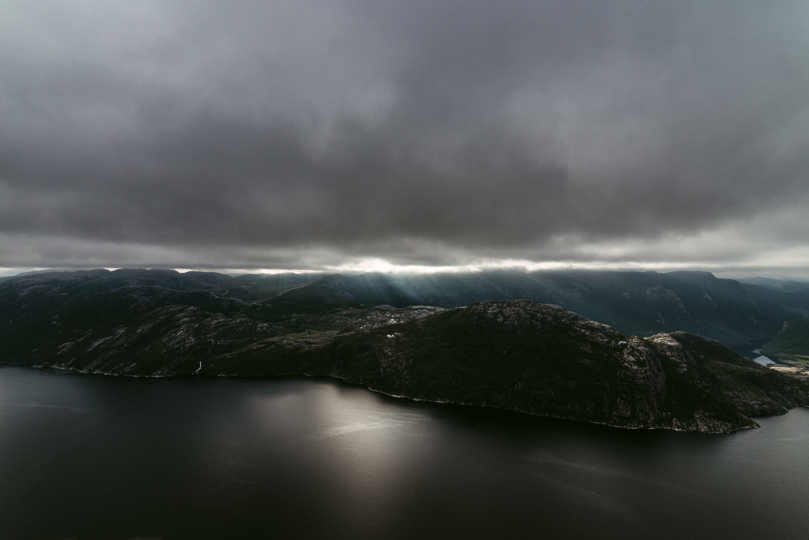Lookout at fjord under dramatic sky