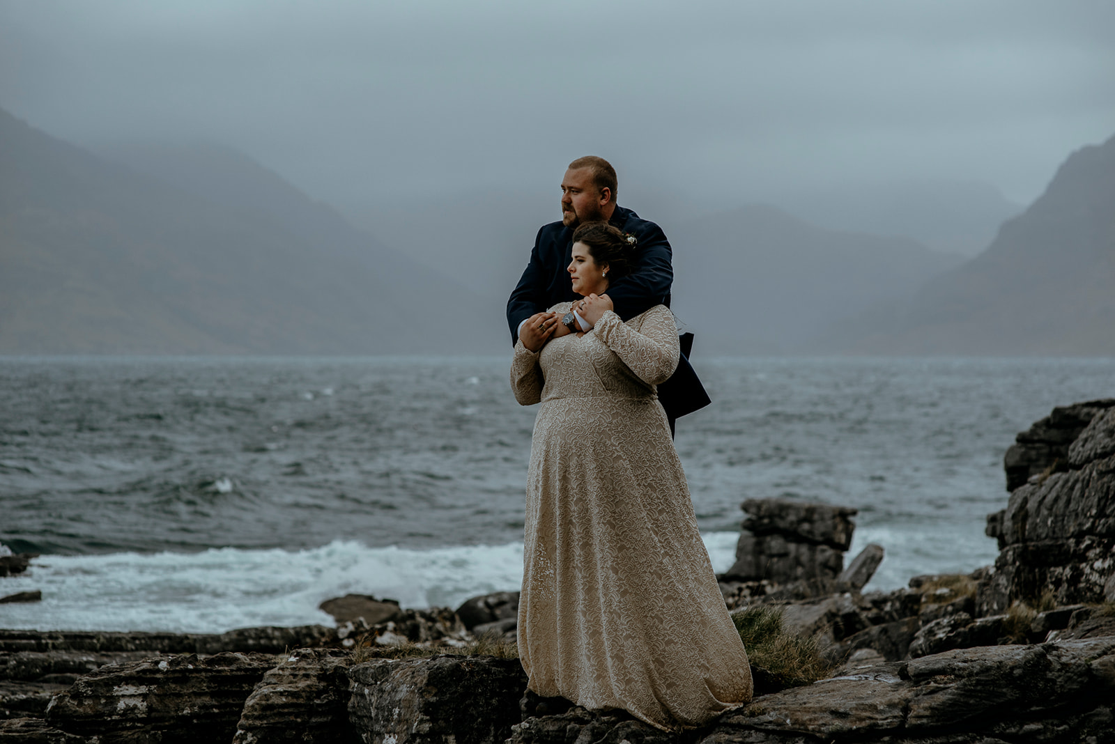 Isle of Skye Elopement Couple standing in front of the Cuillin Mountains