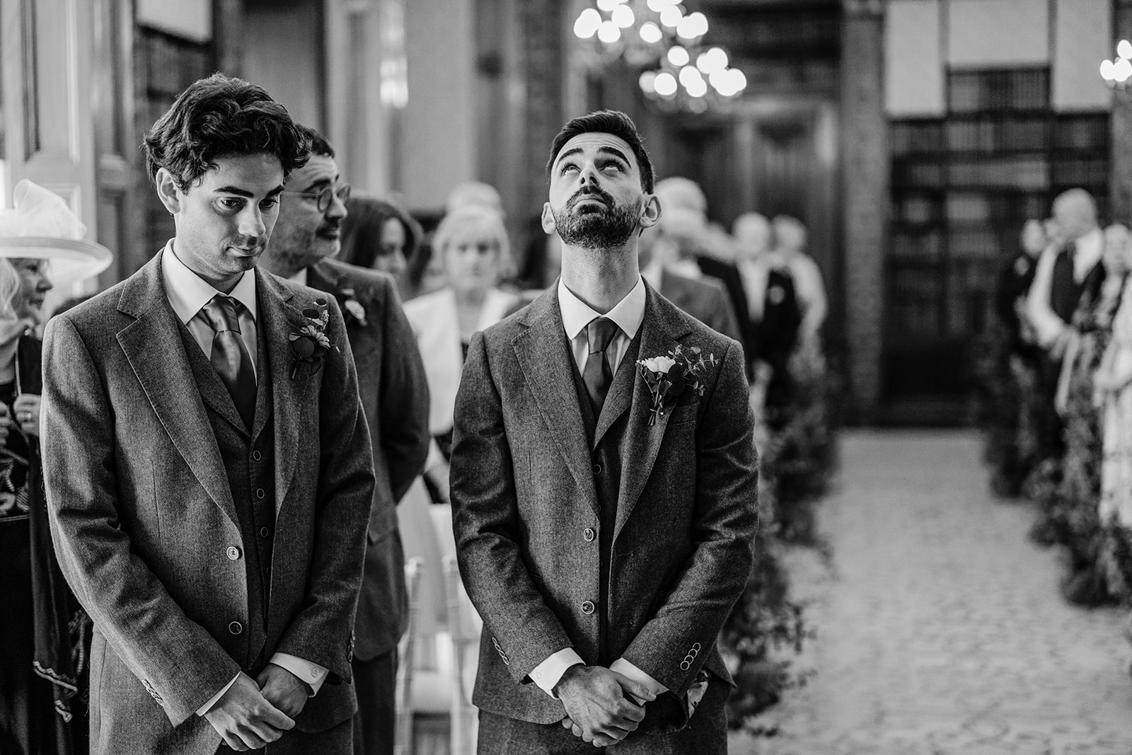 a black and white picture of a nervous groom looking to the heaven just before he sees his bride at Clevedon Hall bristo
