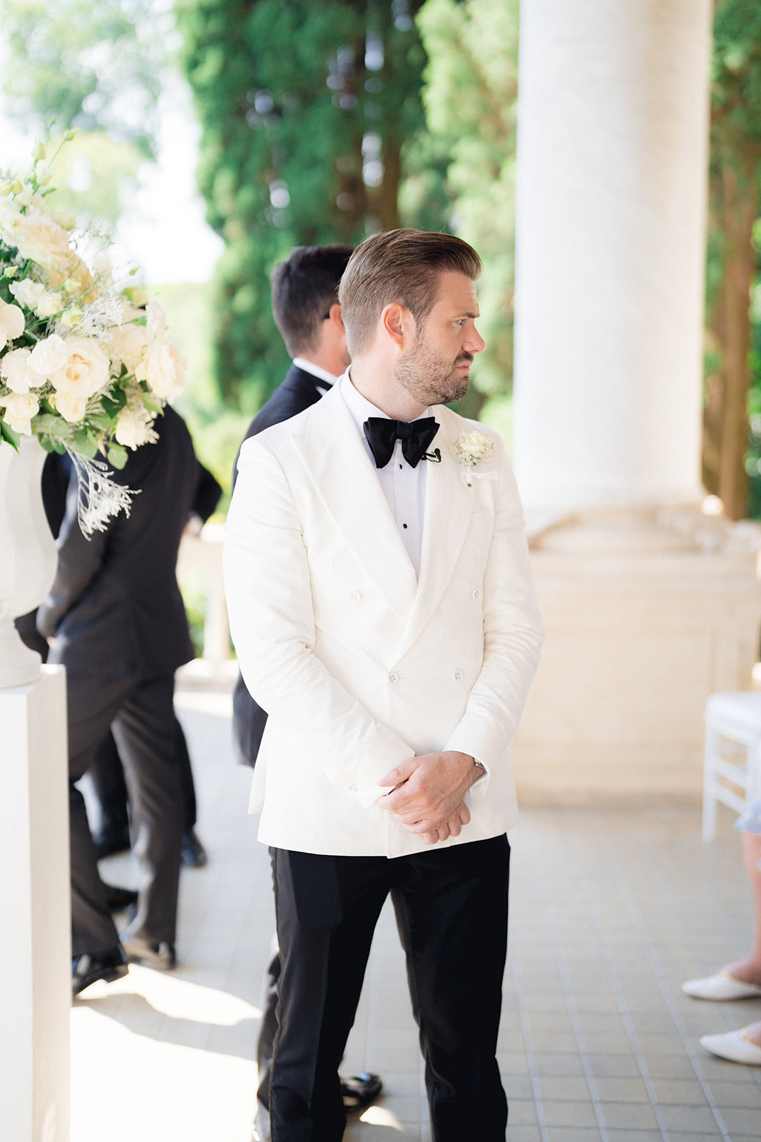 The groom waiting for the bride's arrival, dressed in his tuxedo, for the wedding ceremony at Isola del Garda