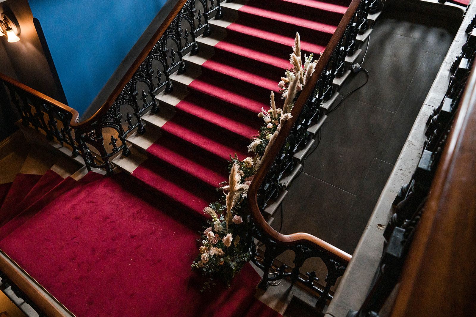grand staircase florals Zara Davis Wedding Photography Cotswolds Grittleton House Gloucestershire Wiltshire