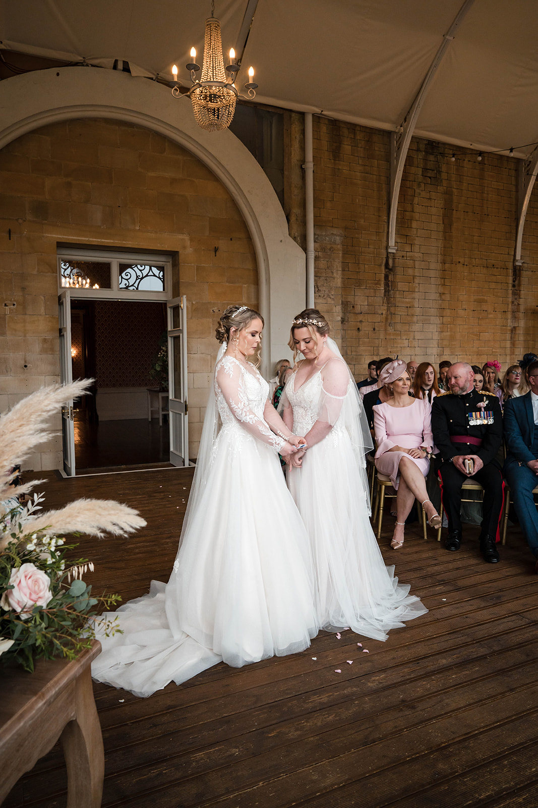 brides looking at each other in ceremony Zara Davis Wedding Photography Cotswolds Grittleton House Gloucestershire Wilts