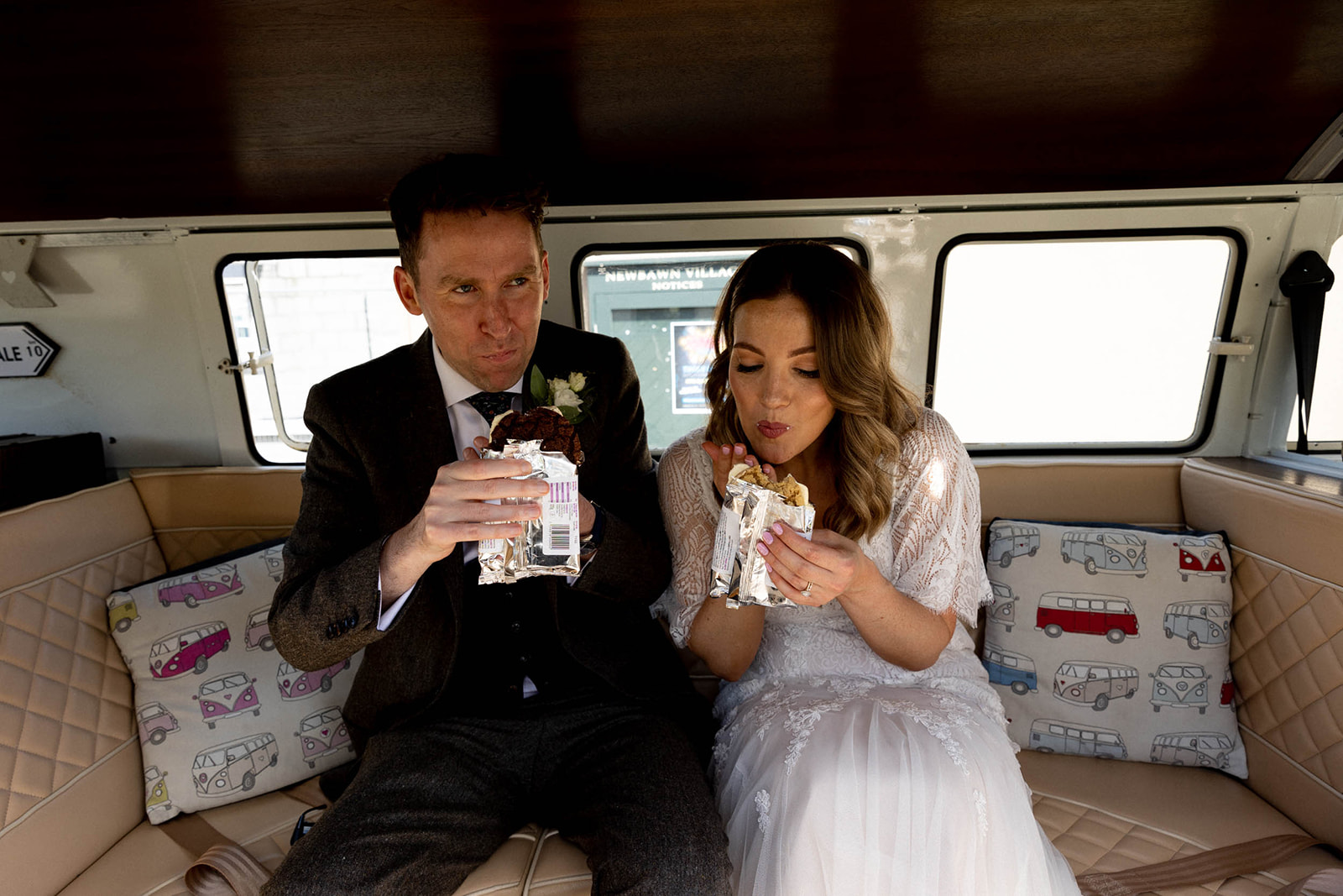 couple eat in wedding car
