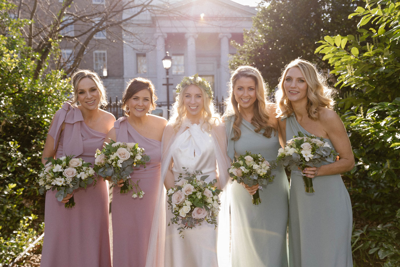 bride with bridesmaids in the sun