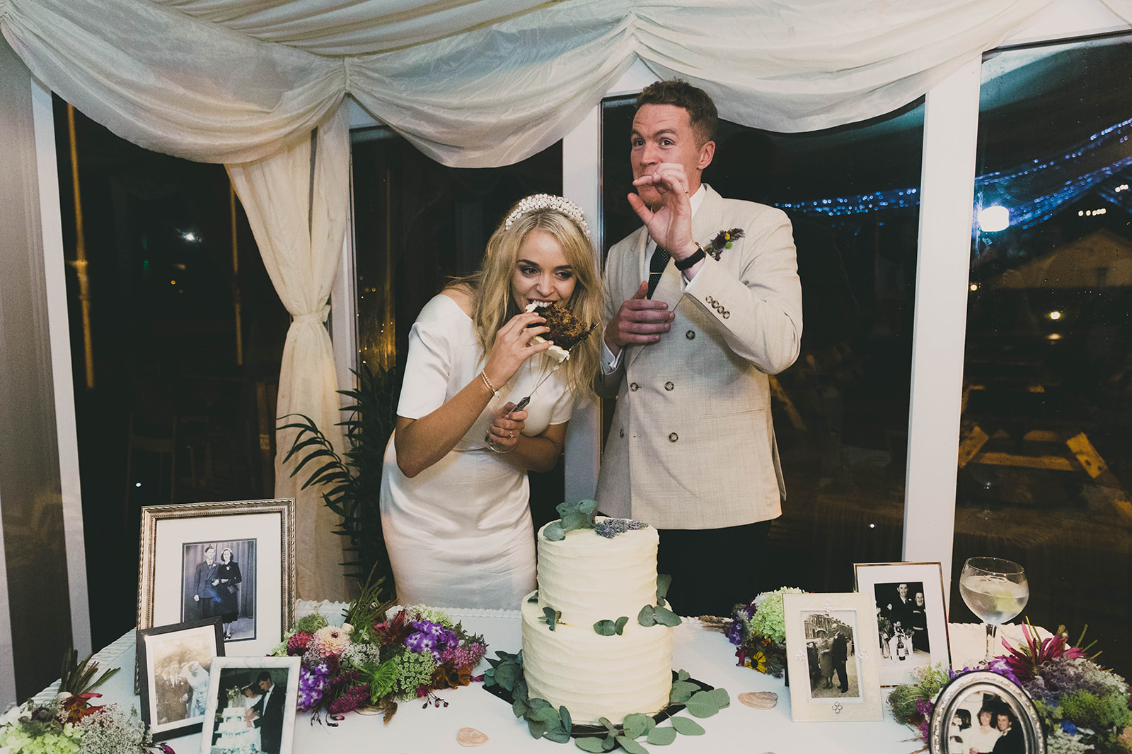 couple eat wedding cake