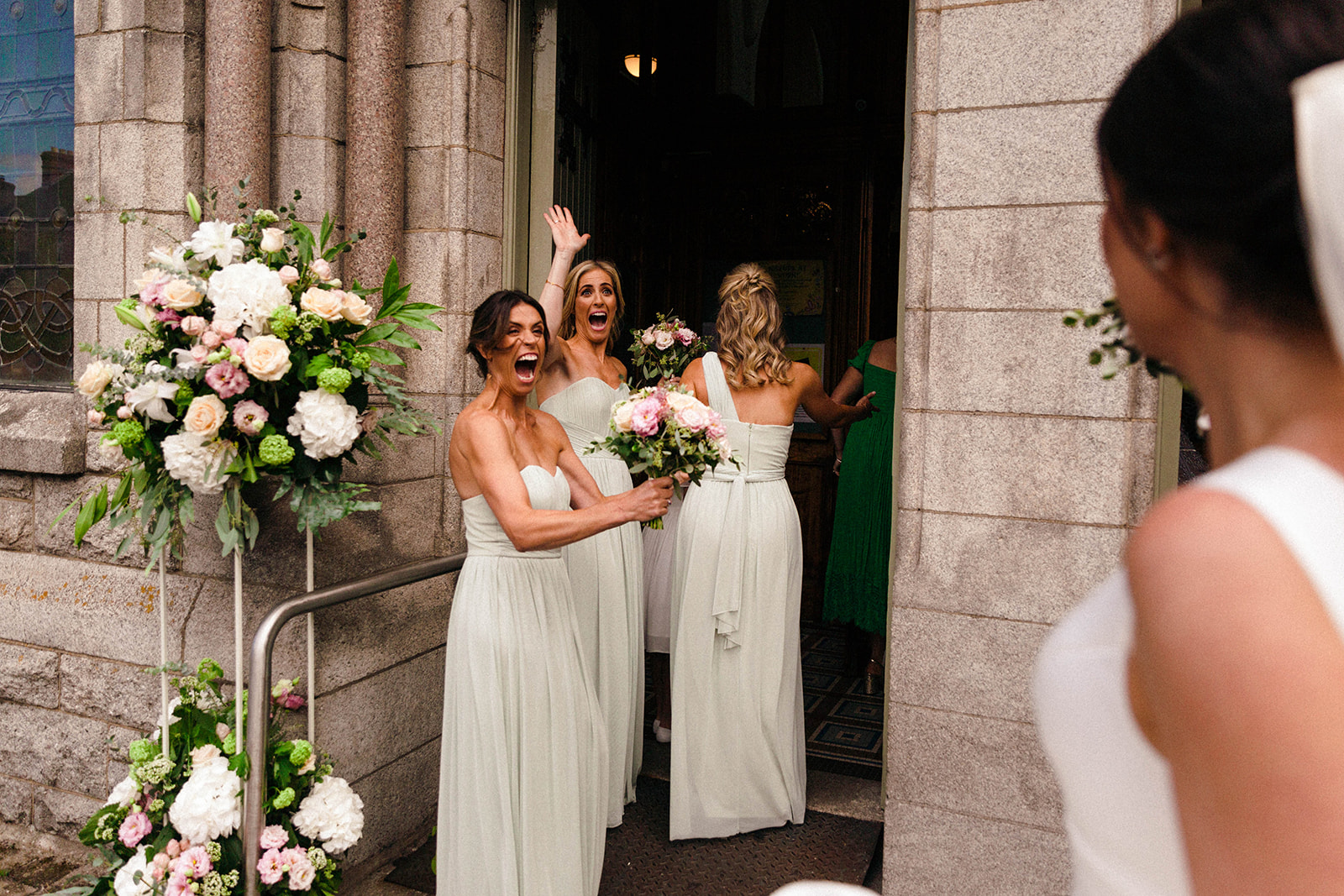 bridesmaids and sisters cheer bride before she goes in to the church