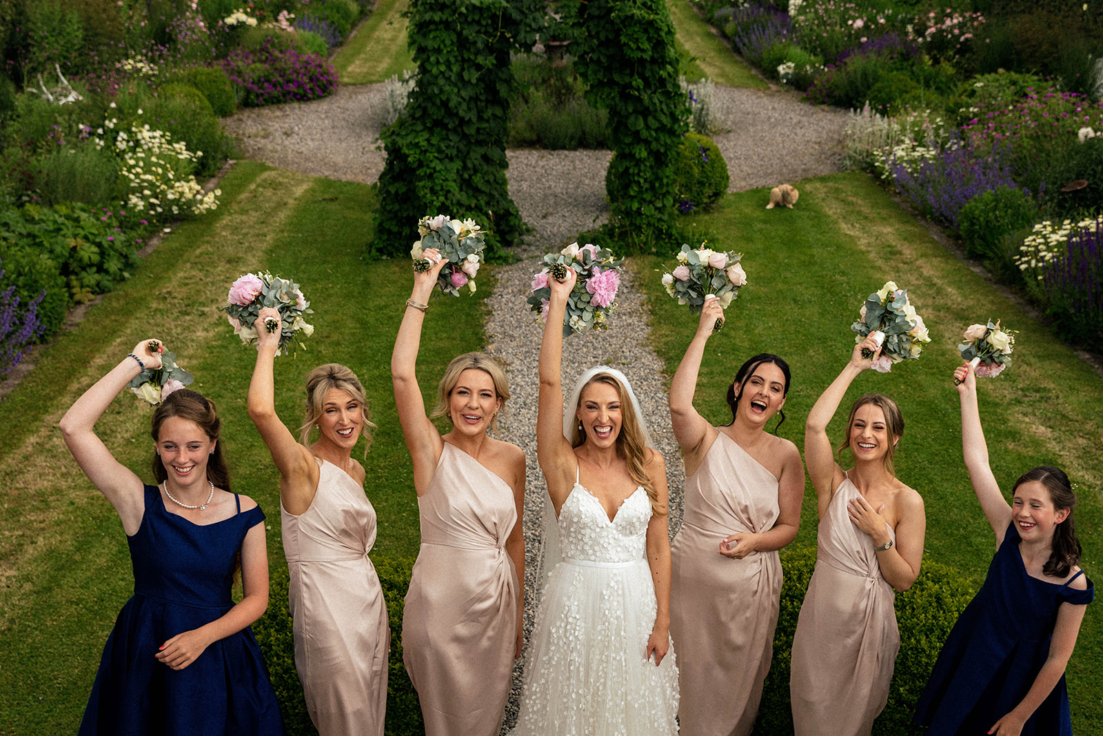 bridesmaids with flowers in the air
