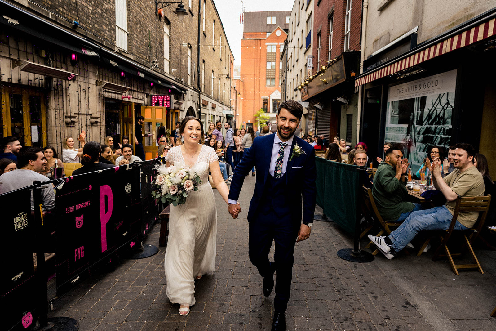 wedding couple walk down dublin city 