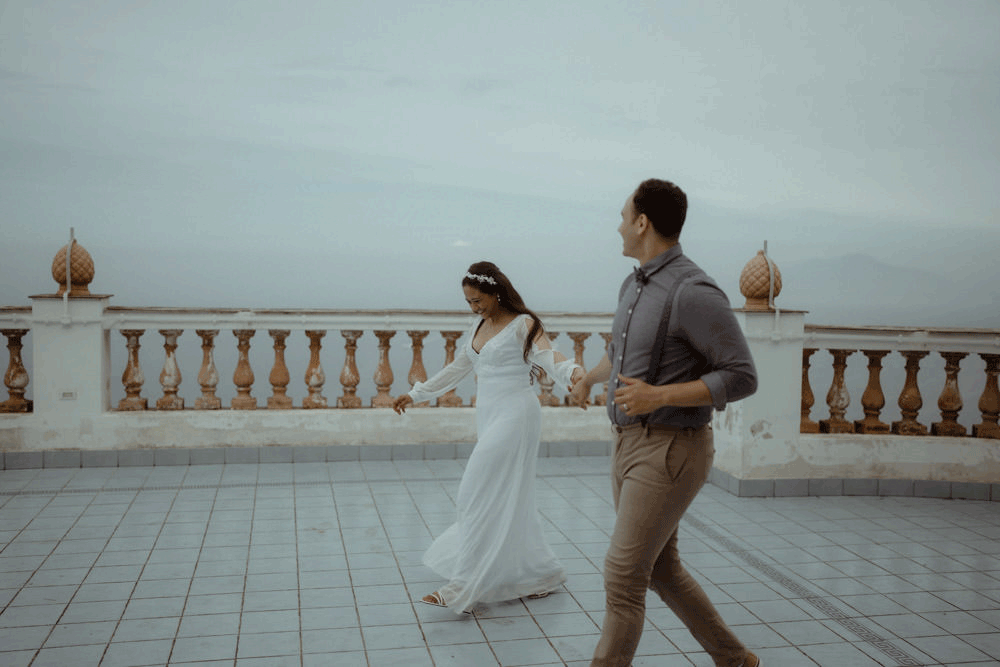 Bride and groom walking on the terrace of Villa Lysis on the island of Capri and turning