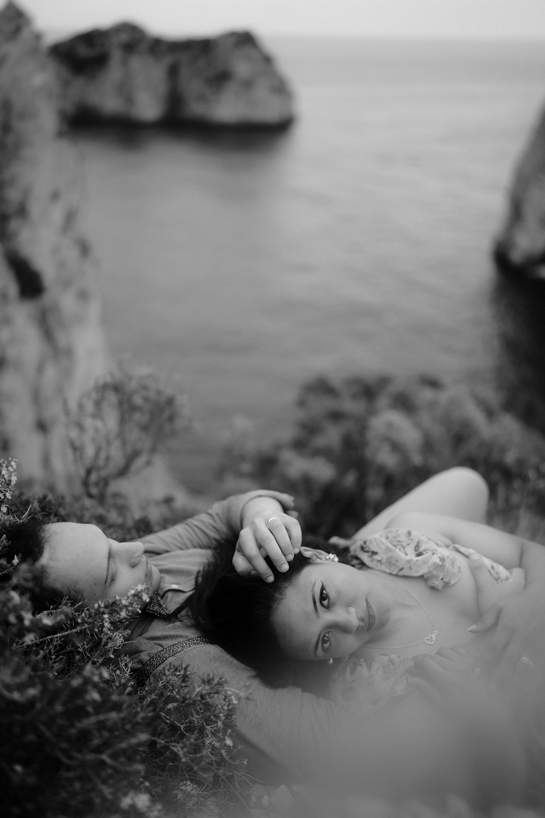 Wonderful couple lying by a cove during a photo shoot on the island of Capri in Italy