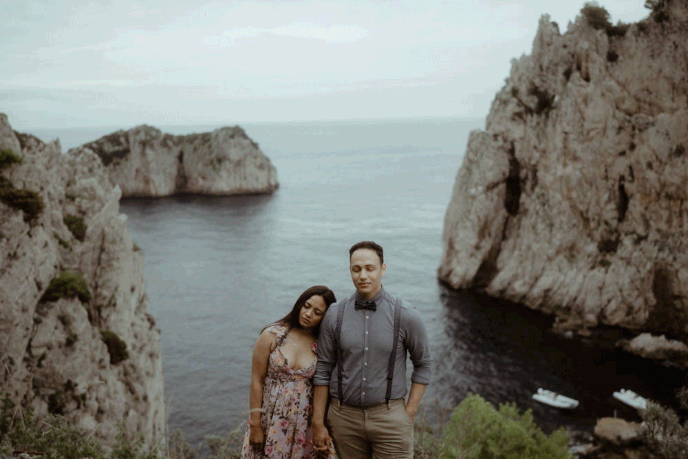 Wonderful couple standing by a cove during a photo shoot on the island of Capri in Italy