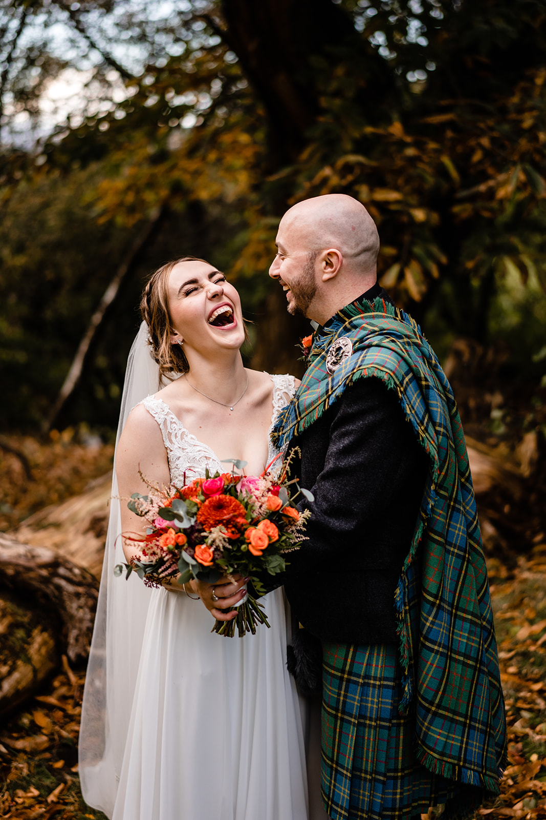 A beautiful autumn backdrop with the wedding couple at Gleddoch Golf & Spa Resort