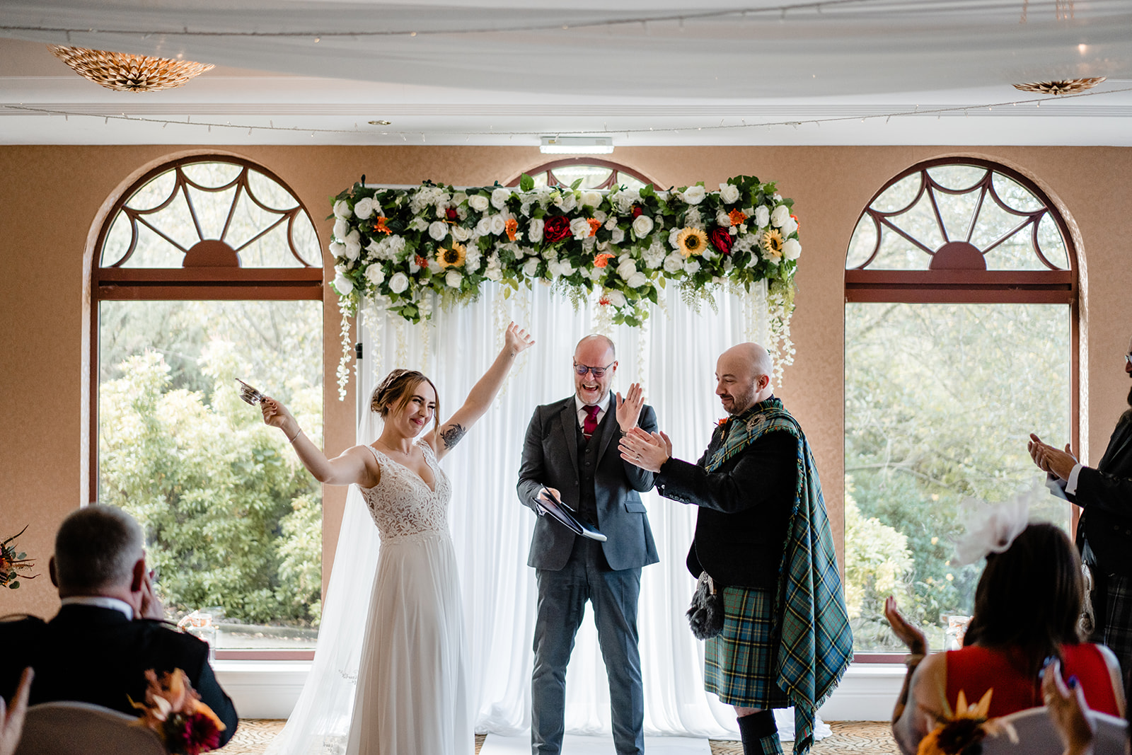 A couple tying the knot at Gleddoch Golf & Spa Resort in front of their family and friends.