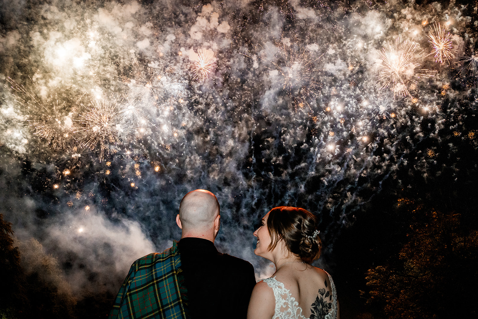 A couple watching fireworks after their wedding at Gleddoch Golf & Spa resort