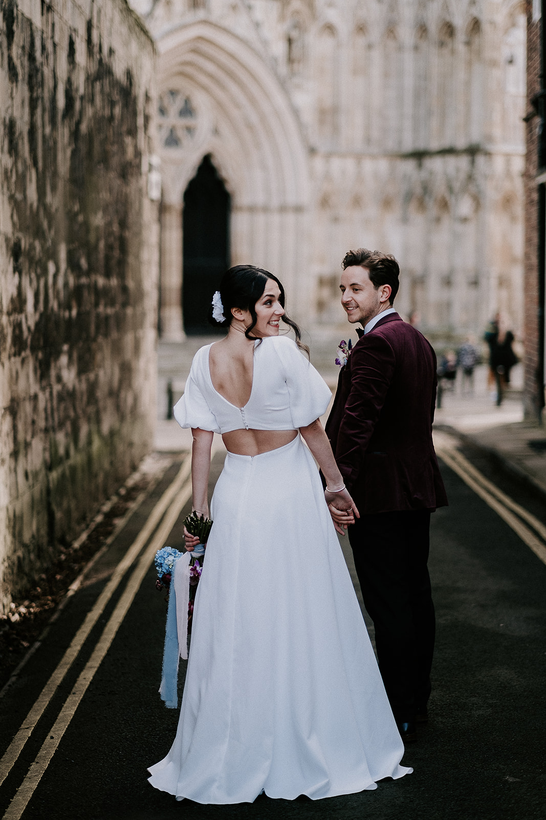 Couple smiling outside of York Minster for their Winter City Elopement 