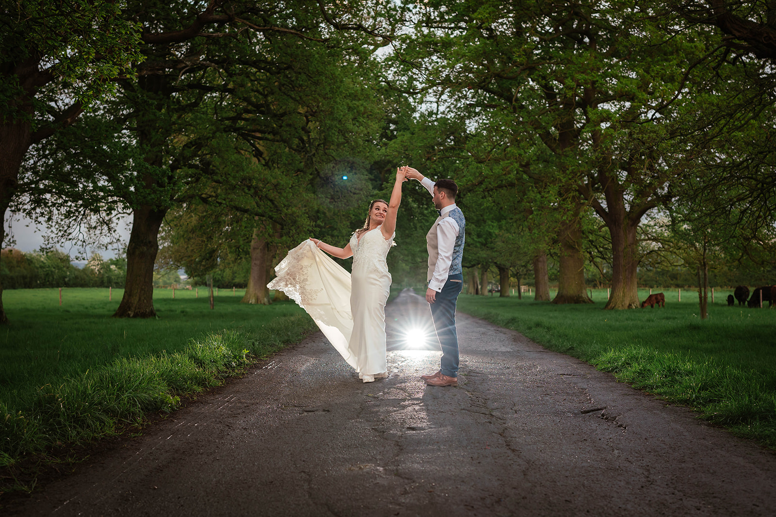 Zara Davis Wedding Photography Moor Farm Moreton Valance Gloucestershire Cotswolds spinning on driveway light