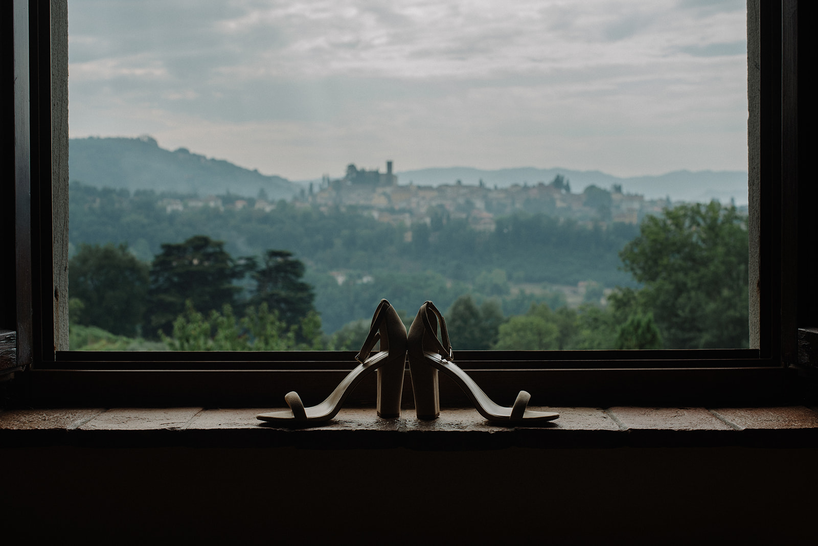 wedding shoes on window sill at I cedri with view of barga town