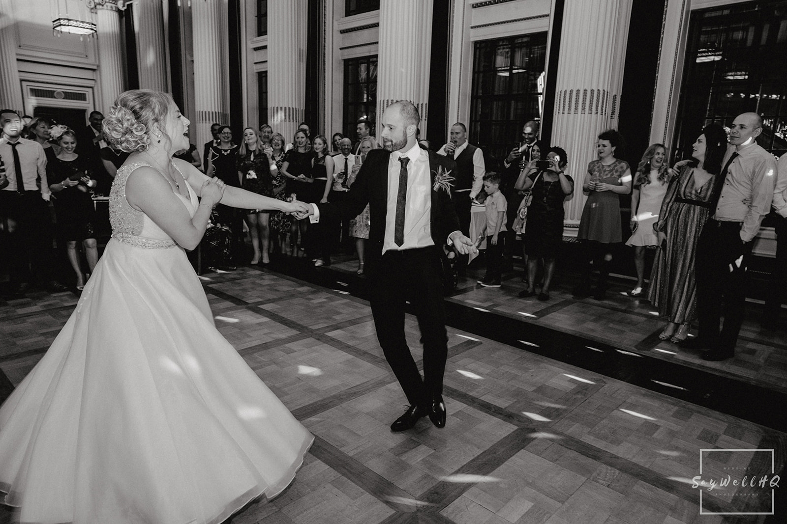 Wedding Photography First dance photos - bride and groom dance in the ballroom
