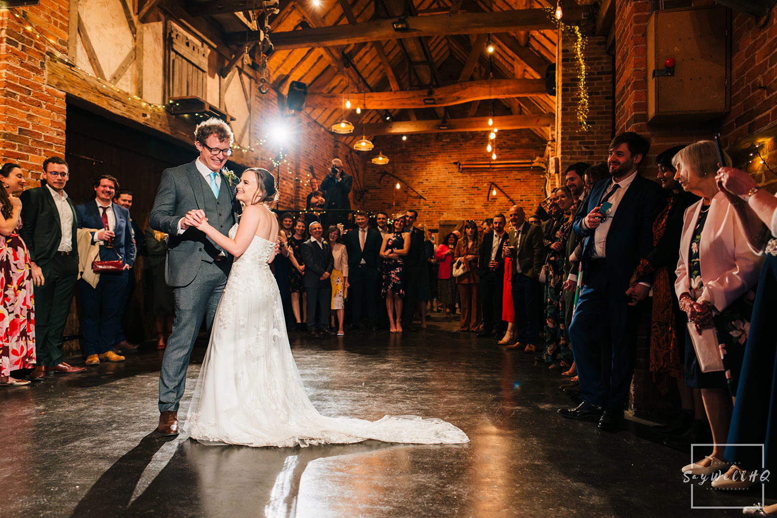 Wedding Photography First dance photos - bride and groom dancing in front of their family and friends

