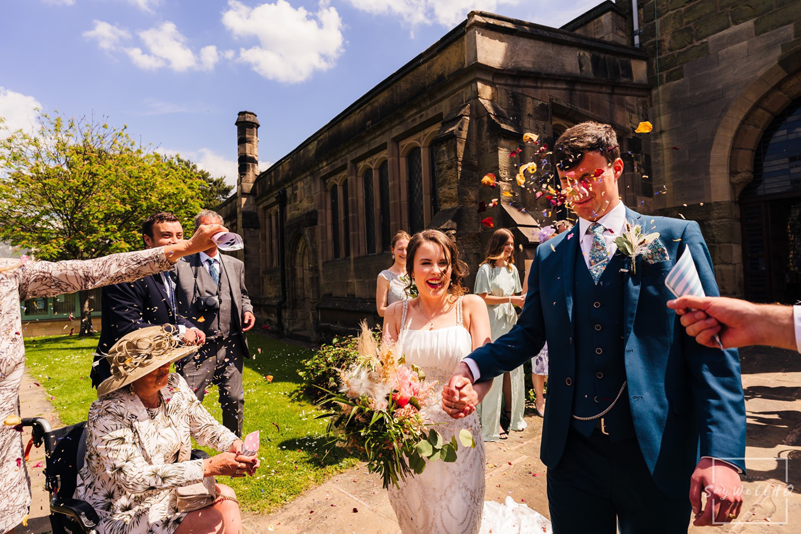 Documentary Wedding Photography Portfolio - Andy Saywell - bride and groom getting covered in confetti
