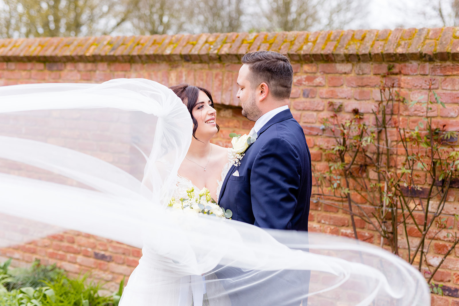 A couple who had an amazing wedding at Apton Hall standing in the Walled Garden