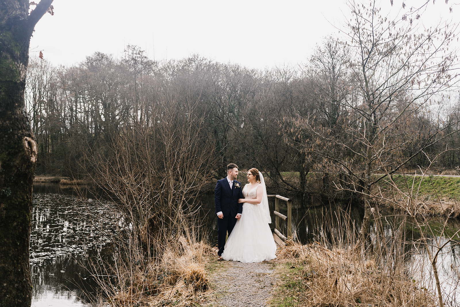 Wedding couple photos by the lake at Llanerch Vineyard