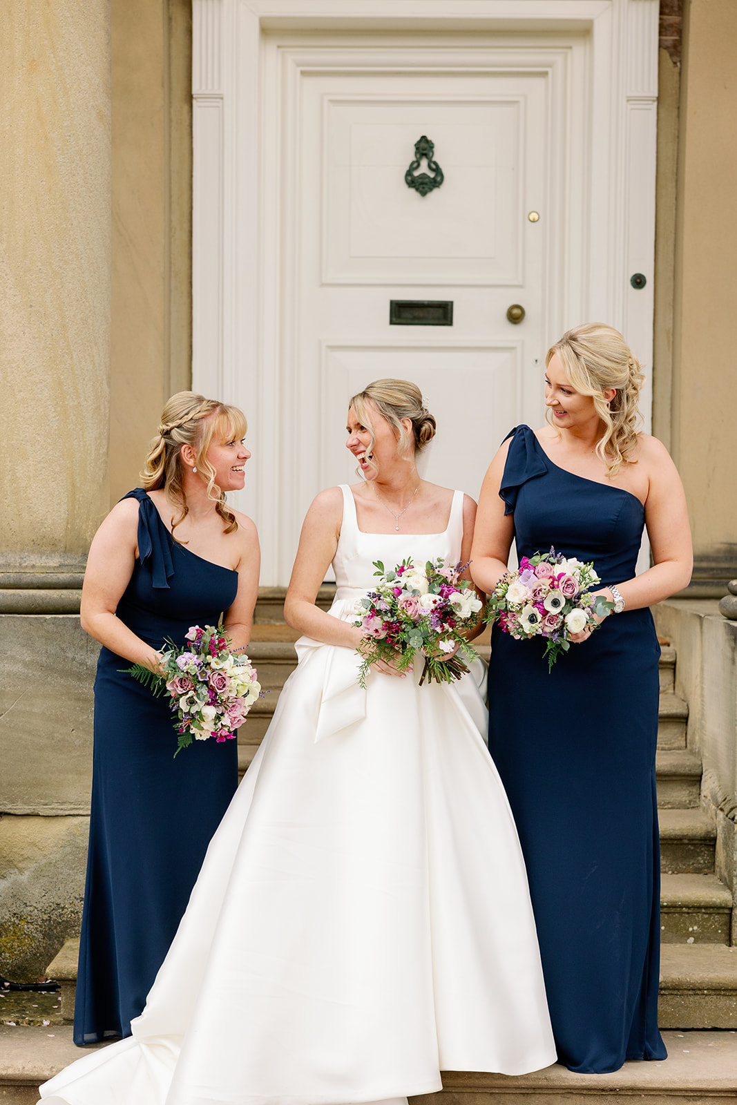 bride and bridesmaids laughing at each other