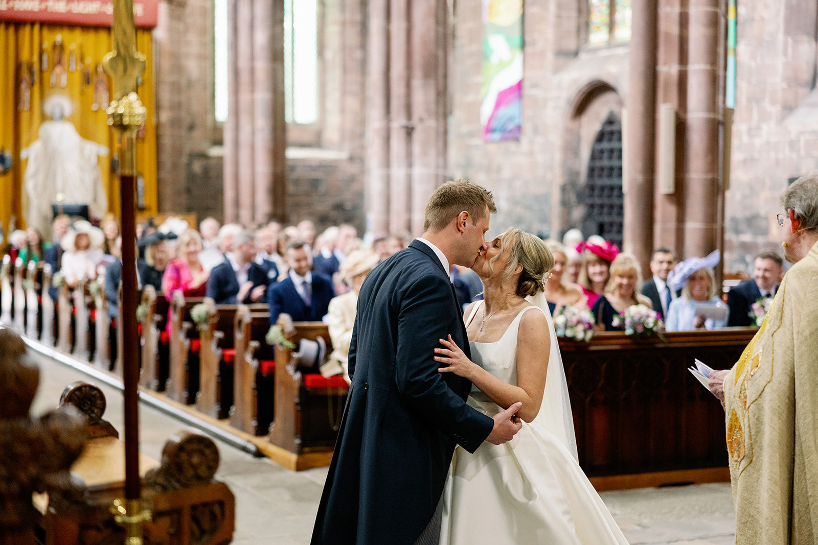 a couples first kiss at st marys church in nantwich