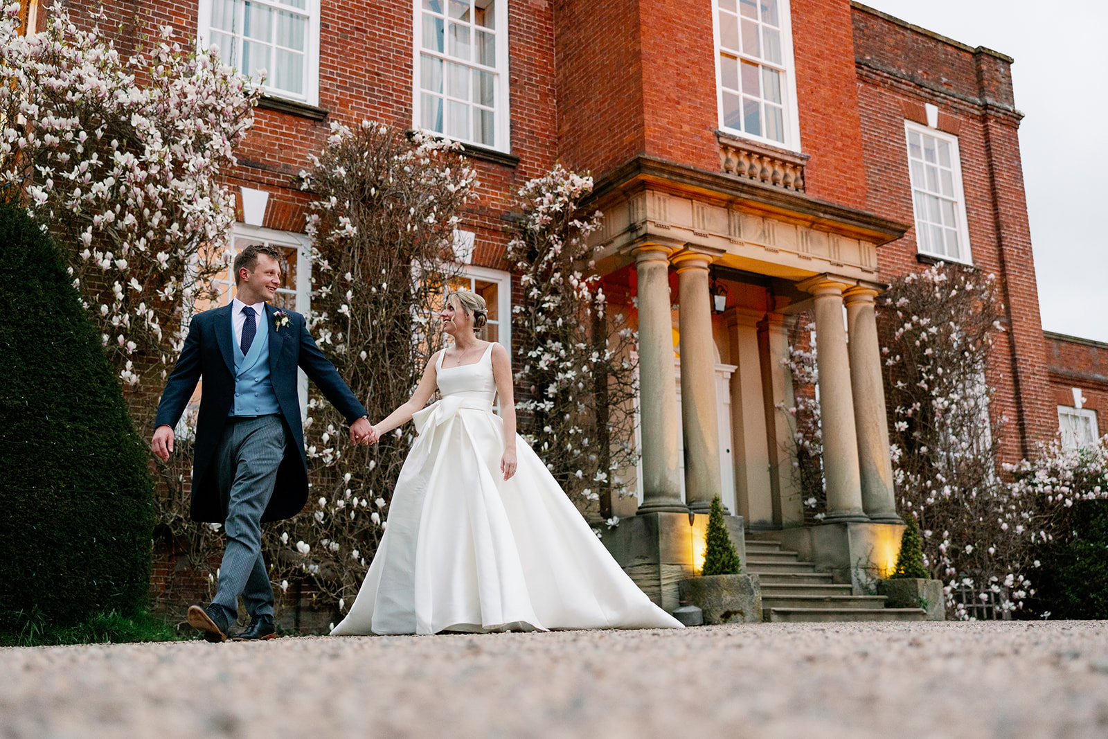 wedding couple walking in front of the main house at Iscoyd Park