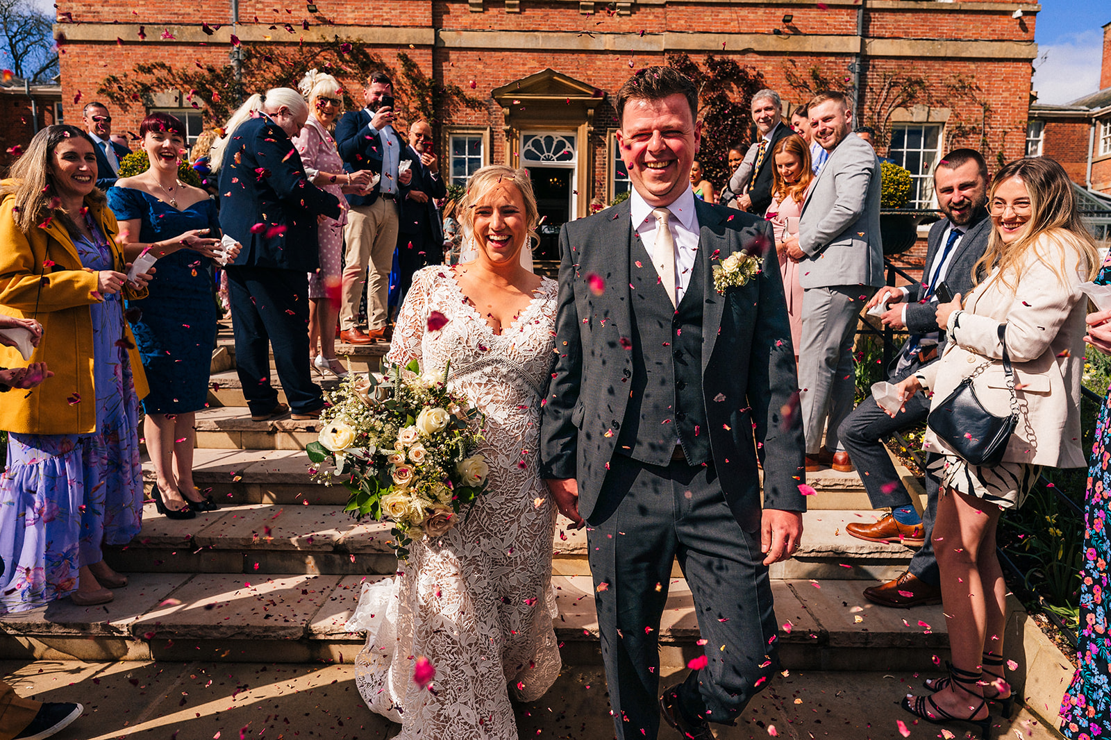 The bride and groom get covered in confetti at Norwood Park