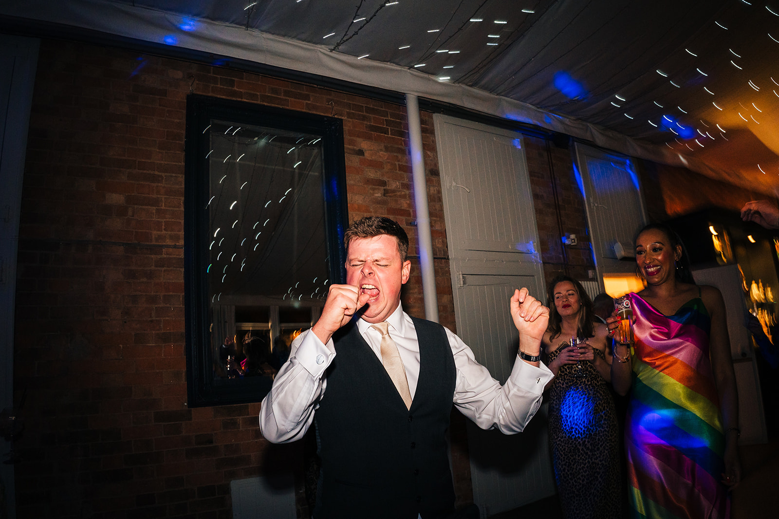 The groom pretending to sing to a song play by the live band at Norwood Park