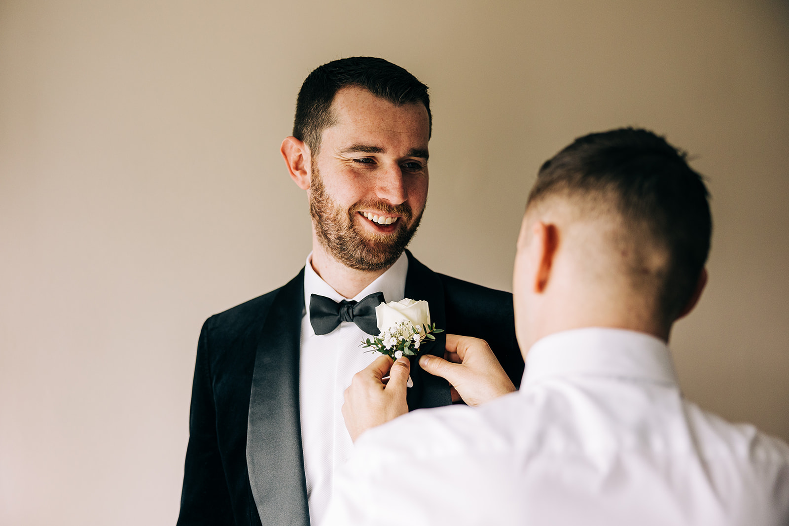 Seán has his groom man pin in his buttonhole flower