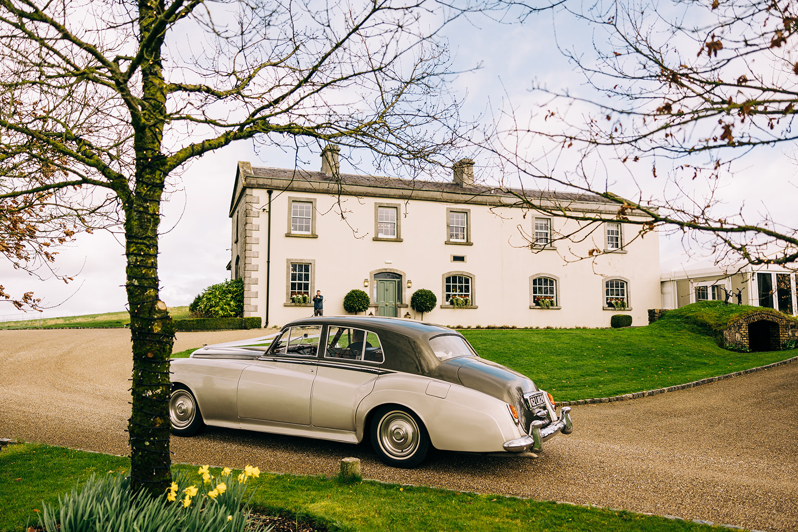 The bride and groom arriving to Clonabreany House in the wedding car