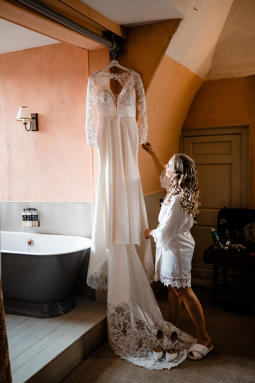 bride hanging her wedding dress at neidpath castle, st Mary's chamber