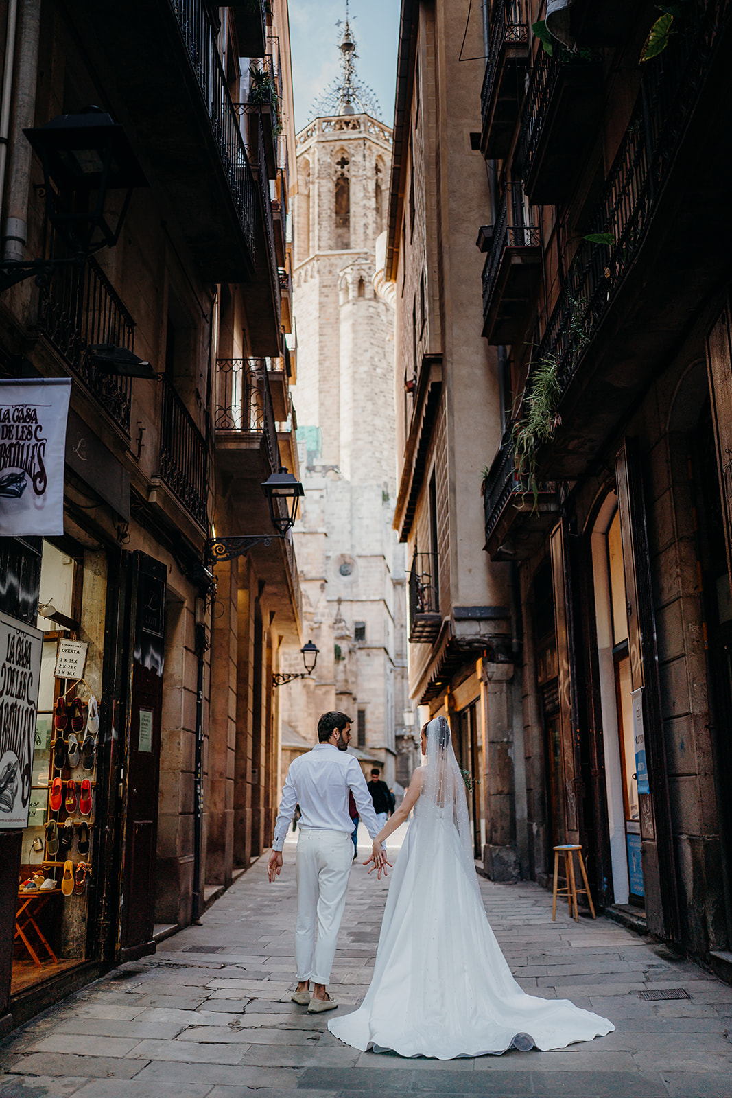 Bride and groom walking through the gothic quarter