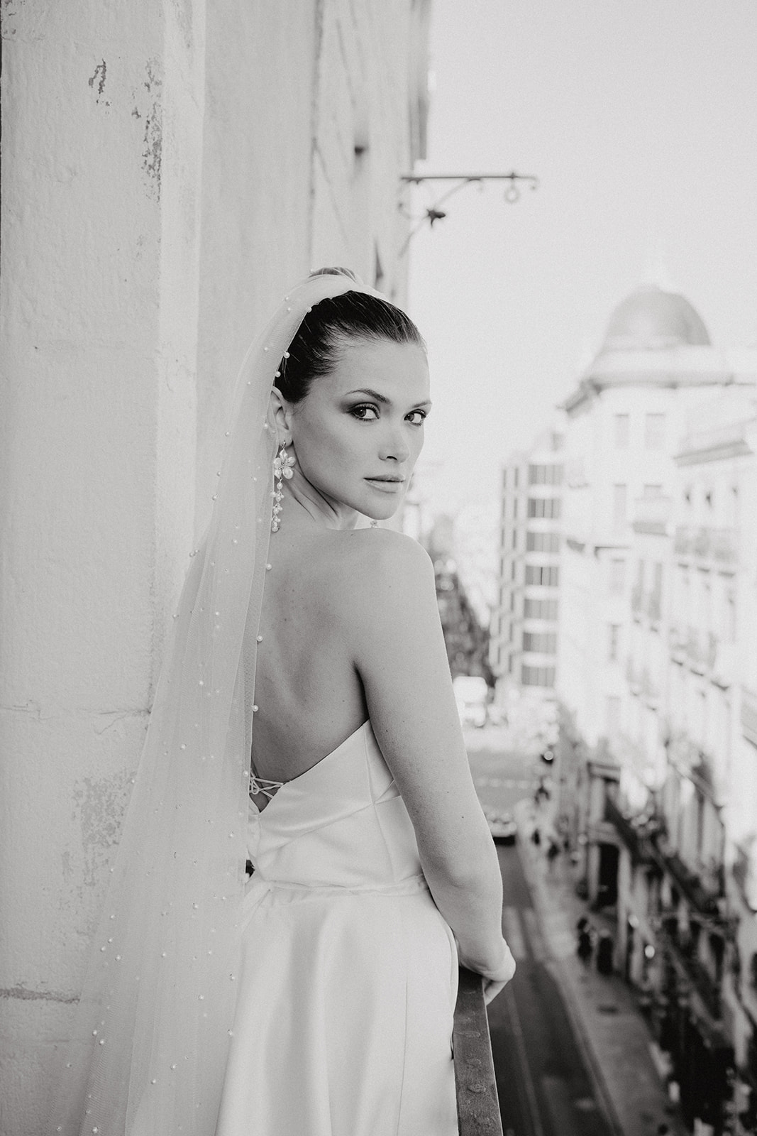 Black and white portrait of bride on balcony