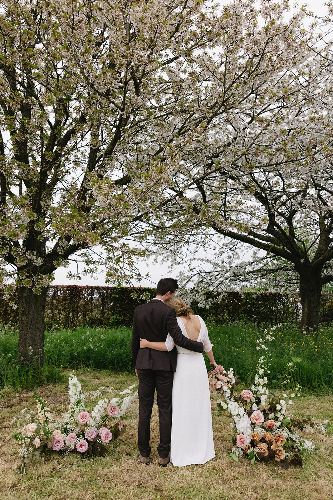 Bride and groom sharing a tender moment in natural surroundings