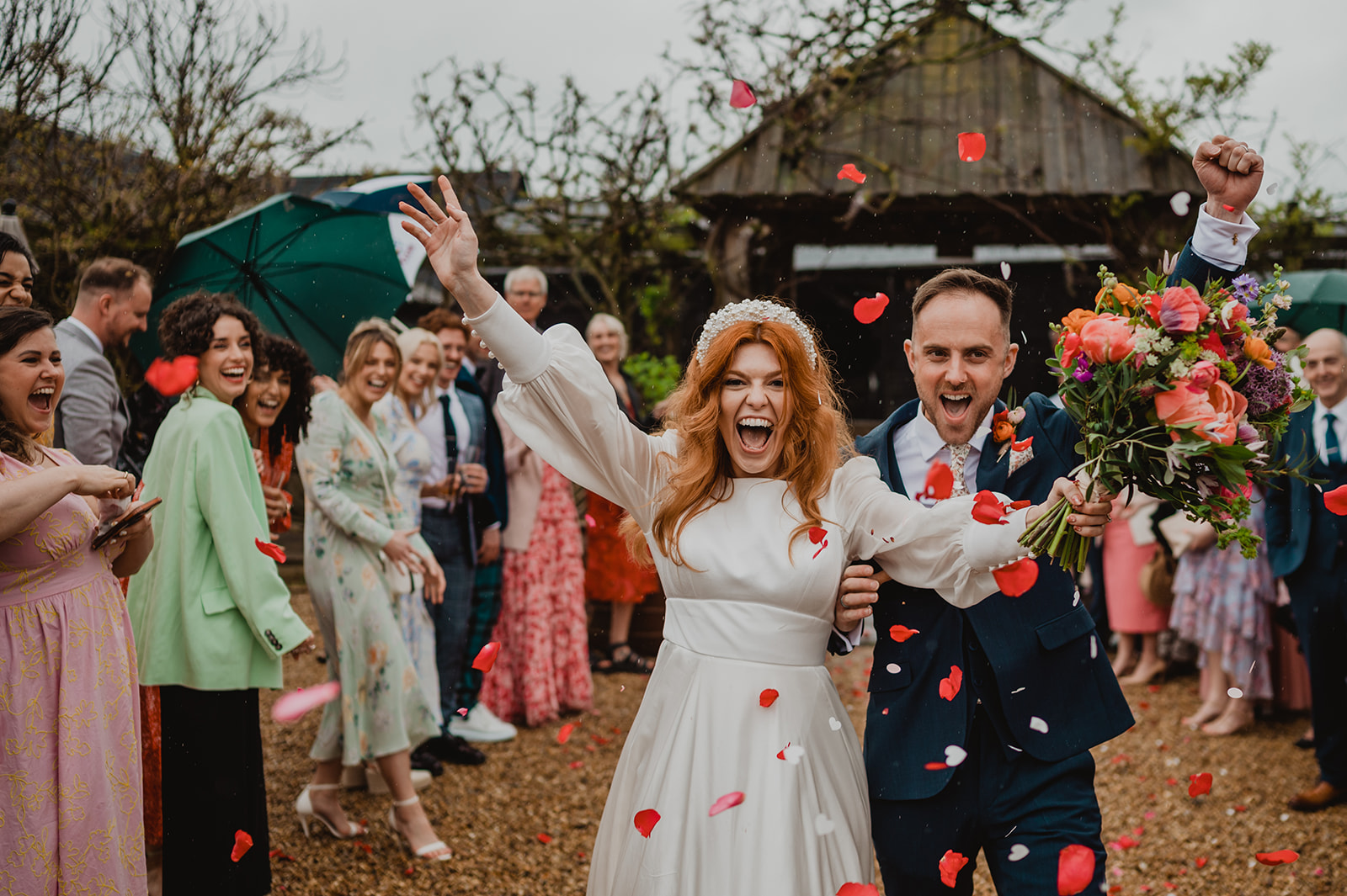 A couple celebrate during the throwing of confetti at South Farm wedding venue