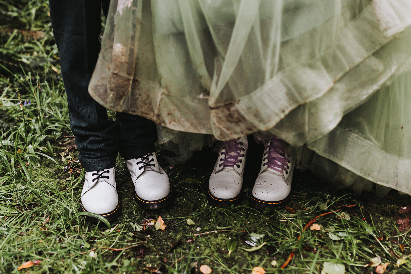 bride and groom wearing matching dr martens in rain
