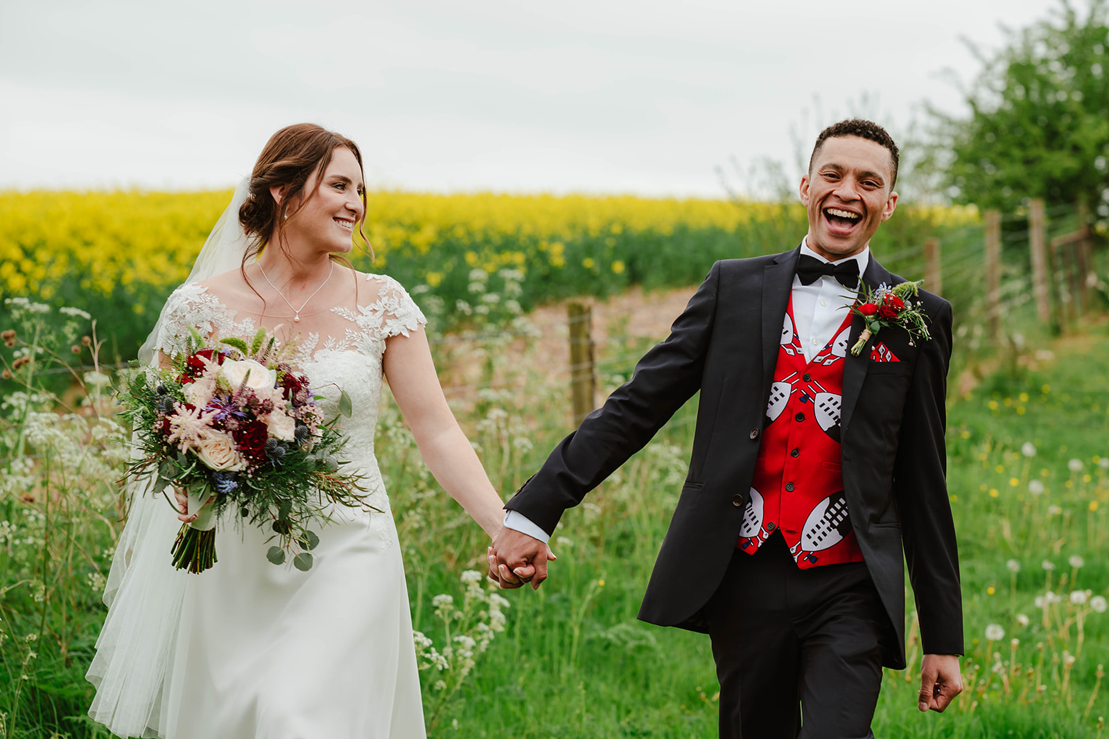 bride and groom laughing on a walk