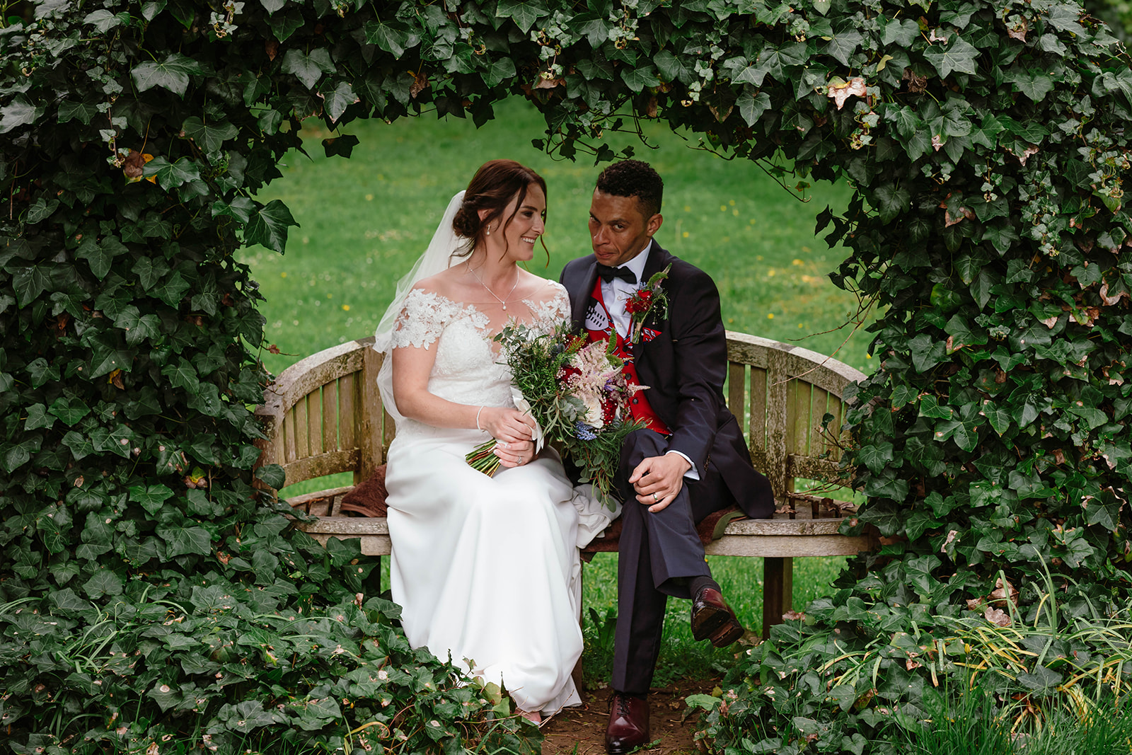 Bride and Groom sat on bench during portraits