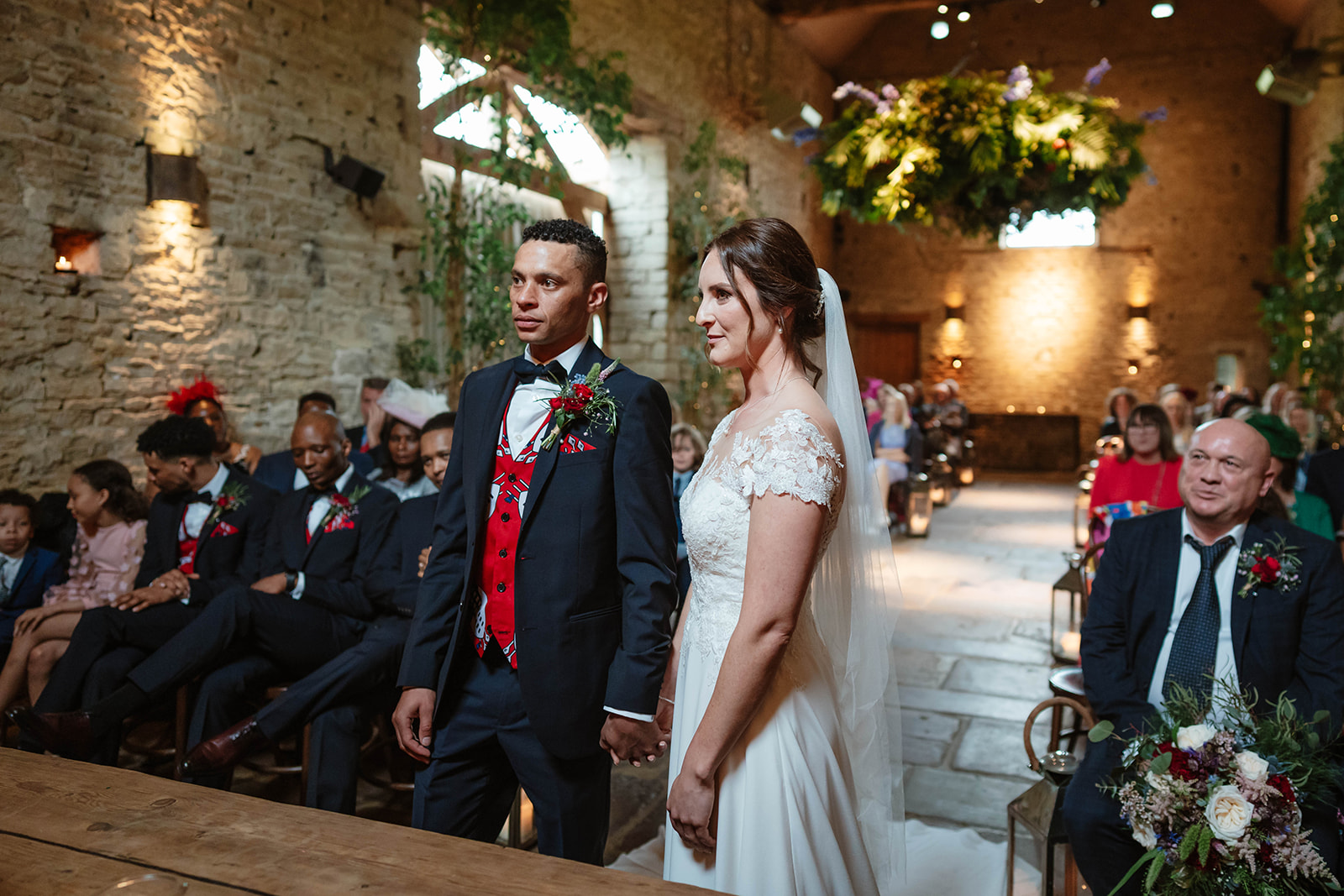 bride and groom stand at the top of the aisle at cripps barn